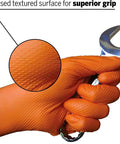 8 Mil Orange Diamond Textured Nitrile Gloves For Heavy Duty Auto And Industrial Tasks 100 Count Extra Size holding a wrench with superior grip