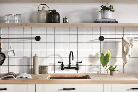 Elmhurst Two-Handle Wall-Mount Kitchen Faucet Oil-Rubbed Bronze, 8-Inch Spout Reach, High-Arc Gooseneck Swivel against tile backsplash