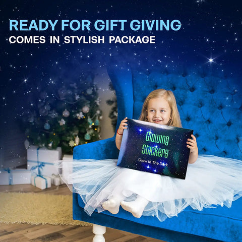 Child holding gift box of Night Sky Glow Stars Ceiling Stickers Kit With 1049 Pieces Including Moon And Stars