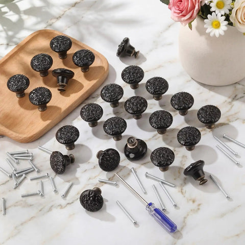 24 Piece Black Ceramic Cabinet Knobs Vintage Round Pulls on marble surface with screws and driver for easy installation.