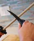 Using CS2 Ceramic Knife Sharpener and Honing Rod 12 Inch for kitchen knife sharpening against polished ceramic surface