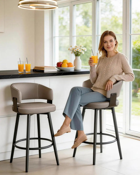 Woman sitting on Set of 6 30 Inch Swivel Bar Stools With Curved Back Mid Century Modern Faux Leather Upholstery in Matte Gray