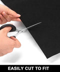 Person cutting Garage Floor Mat 30 X 36 Inches Heavy Duty Oil Spill Absorbent Mat With Waterproof Backing to fit size.