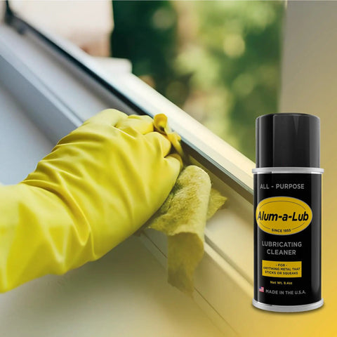 Gloved hand cleaning window track with Go To All Purpose Metal Lubricant And Cleaner Spray For Rust Prevention Polishing And Protection.