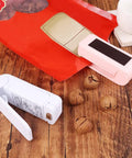 Slick Mini Portable Handheld Bag Sealer For Fresh Snack Storage And Grocery Plastic Packaging Clamps Hassle Free Heat Seal Tool Compact Kitchen Gadget White beside open snack bag.