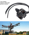 Brushless Motor 2300KV With 420G Max Thrust For FPV RC Drones shown with wires and a drone in the background.