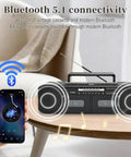 Retro Boombox With Dual Cassette Decks And 7200mAh Battery, Bluetooth Audio on table with smartphone displaying Bluetooth connectivity