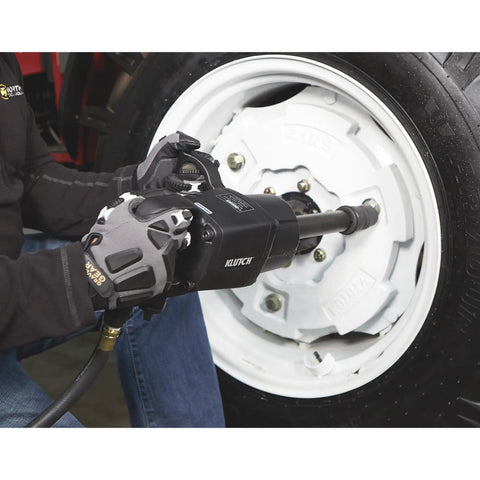 Heavy-Duty Air Impact Wrench With 8 Inch Anvil And D-Handle, 1 Inch Drive, used on a vehicle's wheel in an auto shop.
