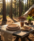 144 Pcs Disposable Rustic Wood Grain Slice Tableware Set For 24 Guests displayed on picnic table in forest setting