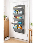 Heavy Duty Over The Door Shoe Organizer Multi Pocket Space Saving Closet Hanger For Sneakers Slippers Socks Sturdy Fabric Storage Rack No Drill Installation mounted on door with cleaning supplies.