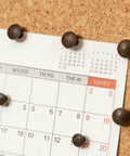 Heavy Duty Antique Brass Upholstery Tacks For Diy Furniture Repair Leather Crafting Auto Interiors Includes Thirty Solid Metal Clavos with a calendar pinned on cork