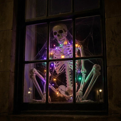 Life Size Skeleton Five Point Four Foot Poseable Full Body Halloween Prop with Movable Joints in window with lights