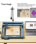 Longer LightBurn camera kit for laser engravers on blue frame with adjustable arm and laptop showing software.