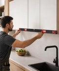 Man using 40-inch Professional Level Set, 3 Piece Aluminum Spirit Level Kit With 40",60",80" to align kitchen cabinets.