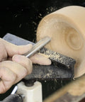 Using Built Solid Three Pack M2 High Speed Steel Bowl Gouge Set For Wood Turning on a lathe with wood shavings flying.