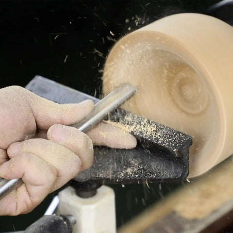 Using Built Solid Three Pack M2 High Speed Steel Bowl Gouge Set For Wood Turning on a lathe with wood shavings flying.