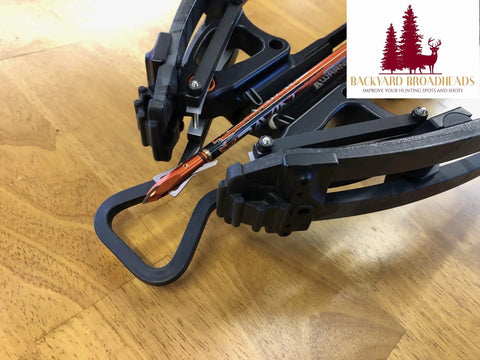 Subatomic Hanger Guard Stirrup For Crossbows Fits R9 R10 R10X R15 R20 R29 R29X LR attached to crossbow on wooden table