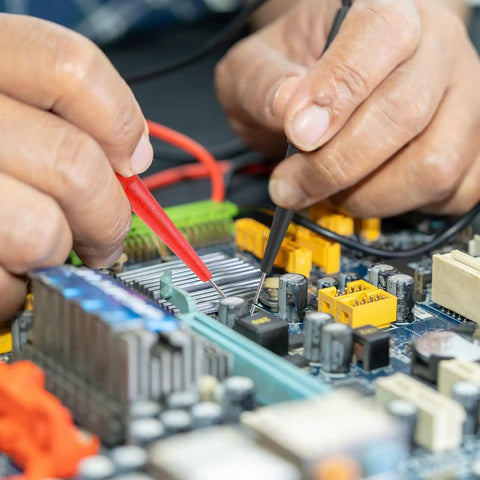 Hands using Back Probe Kit With 4mm Banana Sockets And 0.7mm Non-Destructive Wire Piercing Pins For Car Testers on a circuit board