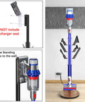 Freestanding Vacuum Docking Station Stand With Six Hooks For V15 Detect And V11 V10 V8 V7 V6 Cordless Vacuum Cleaners Portable Floor Organizer Bracket Made Of Metal No Drill Needed Easy To Move And Store displayed in room next to wall socket.