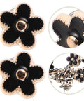 Twenty Piece Black Flower Snap Buttons Slick Metal Clip On Fasteners For Apparel Repairs with stylish black flower design and gold trim.