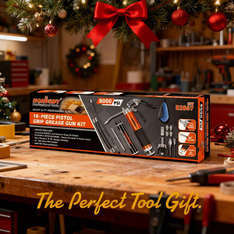 18-Piece pistol-grip grease gun kit box on workbench, orange/black packaging, 8000 PSI, hoses included
