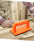 Heavy Duty Woodworking Safety Push Block For Table Saw And Router Tables Badass Shop Gear bright orange push block in use with measuring tape.