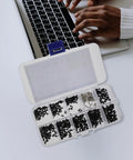 Laptop Screw Kit 500 Piece Flat Head Self Tapping Screws Countersunk Carbon Steel next to laptop keyboard in use.