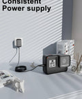 Action camera charging on table with 24V AC DC Power Adapter Charger connected to wall socket