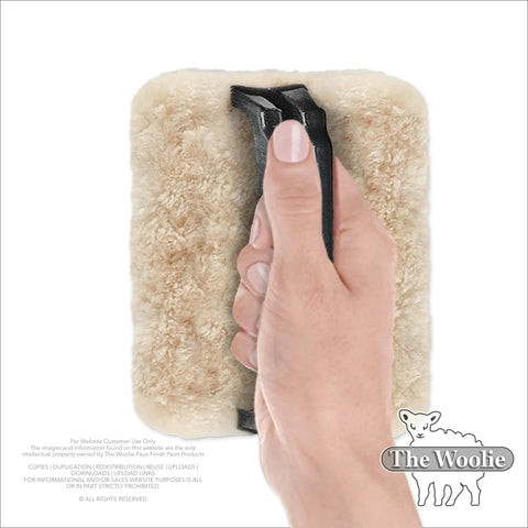 Hand holding USA-made Faux Painting Starter Toolkit For Beginners Full Sized 9.75 By 5 Inch Set with sheepskin pad tool.