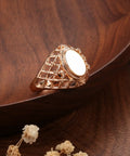 Fresh Rose Gold Oval Mesh Statement Ring For Women Featuring Sleek Polished Surface And Dope Openwork Grid Band on wooden plate.