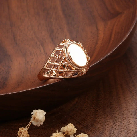 Fresh Rose Gold Oval Mesh Statement Ring For Women Featuring Sleek Polished Surface And Dope Openwork Grid Band on wooden plate.