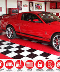 Red car parked on Interlocking Diamond Plate Garage Floor Tiles for a Tough, Easy Clean Garage Makeover, Heavy Duty Copolymer Modular Tiles.