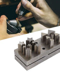 Close-up of Dope 15 Piece Disc Cutter Set with pentagram triangle punch dies on steel base for jewelry making and crafting.