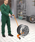 Person using Beefy Heavy Duty Tire Dolly For Garage And Auto Repair Wheel Tire Moving Cart For Transferring Heavy Wheels Safely
