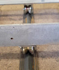 heavy duty sliding gate wheels on rail track showcasing sturdy V-groove design for industrial use