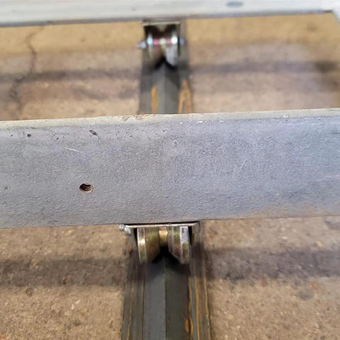 heavy duty sliding gate wheels on rail track showcasing sturdy V-groove design for industrial use