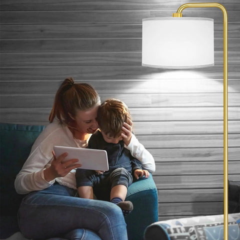 LED Floor Lamp With 3 Color Temperatures And Foot Switch, Tall Gold Standing Lamp For Living Room, Bedroom, Study Or Office, 9W E26 Bulb Included, 810LM Brightness, Modern Design, Easy To Use lighting up a cozy room scene with family.