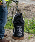 Person holding Beefy Heavy Duty Canvas Tool Bucket With Zip Top Flame Resistant Closure For Overhead Lifts, 100 Pound Load