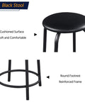 Black stool with cushioned seat and round footrest, part of Adjustable Drafting Desk With Stool Multifunction Artist Table.