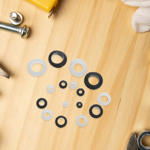Rock Solid 180 Piece Rubber Grommet Kit With Nylon Washers For Waterproof Cable Sealing And Wire Protection. Perfect For Electrical Wiring, Plumbing Projects, And Home Insulation. Keeps Moisture Out While Guarding Cables In Any Damp Environment. Heavy. rubber grommets and nylon washers on wood surface