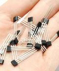 Top Tier Hall Effect Sensor Magnetic Detector Pack Of Twenty For Arduino Projects Offering Four Point Five To Twenty Four Volt Operation And Reverse Polarity Shield Delivers A Kickass Setup For Street Rod Wiring And Smooth Electronic Switching Control in hand, showing individual sensors.