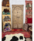 Hand Carved Barn Door With Natural Finish, Rugged Rustic Solid Wood Interior Door For Sliding Or Hinged Use, Custom Size Available, Double Or Single Door, Made To Order Architectural Woodwork For Home No Glass Or Hardware Included in a colorful room setting with ethnic decorations.