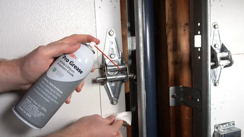 Applying Teflon White Lithium Grease Aerosol Spray 10 Oz For All Weather Lubrication to garage door hinge