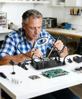 Man using Magnetic Helping Hands Soldering Station With 5X LED Magnifying Lamp 6 Flexible Arms for electronics DIY project
