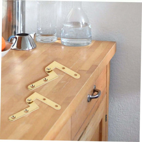 Rotatable Copper Pivot Door Hinges Set for Hidden Doors and Cabinets on wooden countertop, showing durable copper construction.