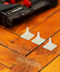 Self Adhesive PCB Standoffs With Hella Secure Insulated Foot Pads For Circuit Boards and Motherboards on wooden surface.