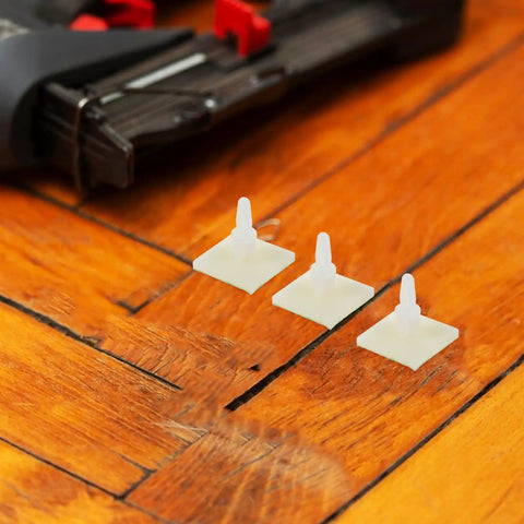 Self Adhesive PCB Standoffs With Hella Secure Insulated Foot Pads For Circuit Boards and Motherboards on wooden surface.