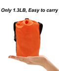 Orange bag for 50 Ft Dog Tie Out Cable With Overhead Trolley System, lightweight at 1.3 lbs, easy to carry, resting on a hand.