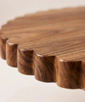 Close-up of scalloped edge detail on 13 Inch Acacia Wood Cake Stand With Lazy Susan Rotating Turntable.