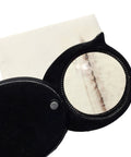 Retractable hand lens from Rock And Mineral Identification Kit With 7 Tools for Quick Rock And Mineral Testing and streak plate